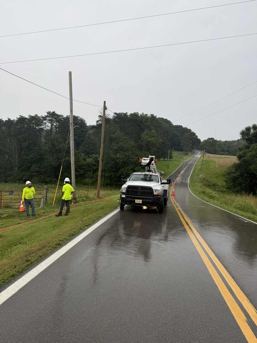 Roadside line work on a wet morning