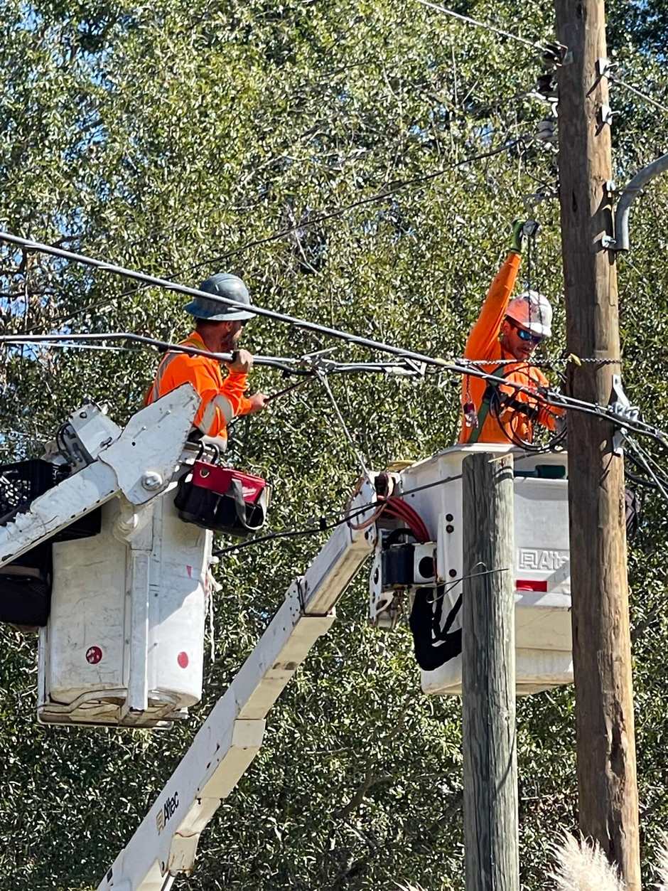 Crews rebuilding the network, pole by pole